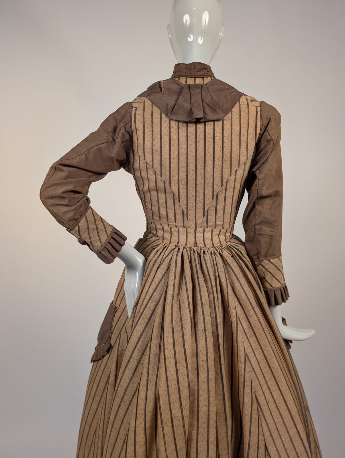 LATE 1860’S PINSTRIPED TAN BOMBAZINE DRESS W BOWS + SIDE POCKET DETAIL