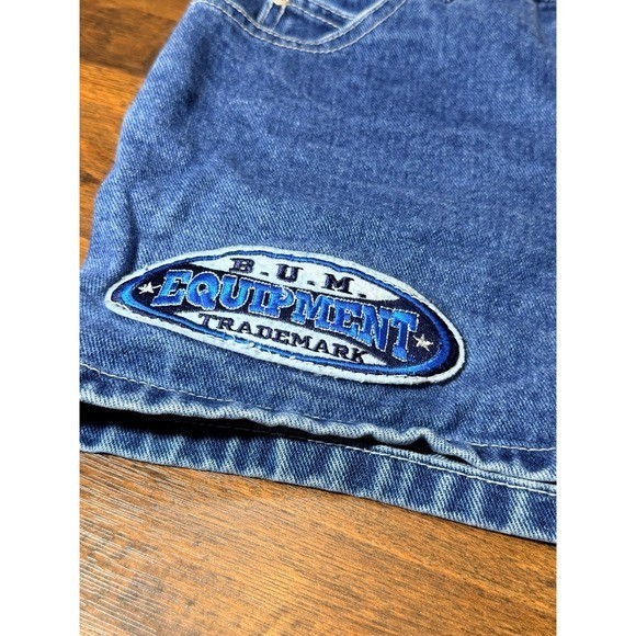 Vintage 1990s BUM equipment denim shorts with large logo patches. SZ 7 waist 28