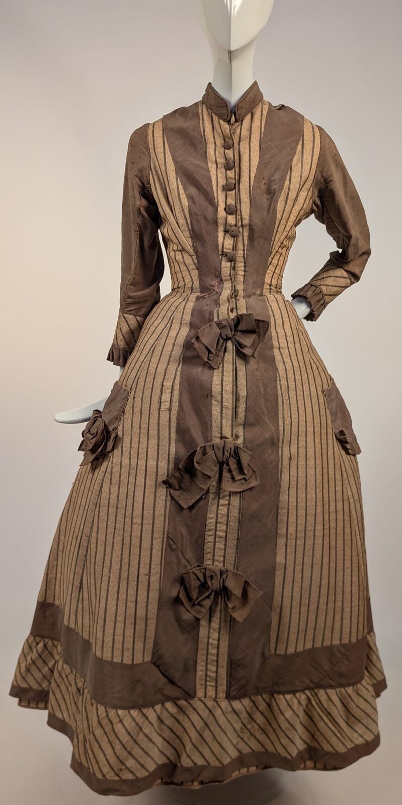 LATE 1860’S PINSTRIPED TAN BOMBAZINE DRESS W BOWS + SIDE POCKET DETAIL