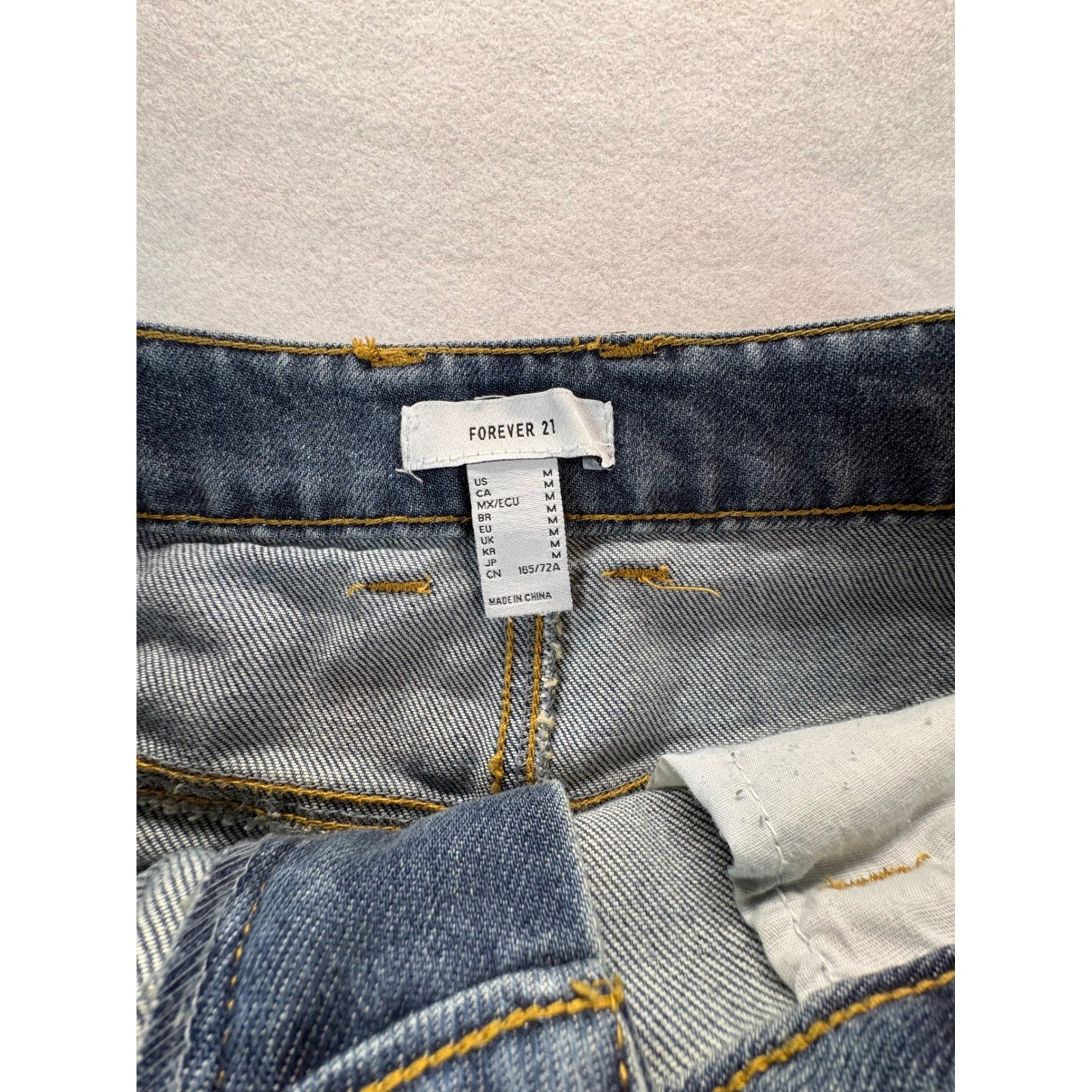 Forever 21 Denim Mini Skirt Women’s Medium Distressed Raw Hem Blue Pockets