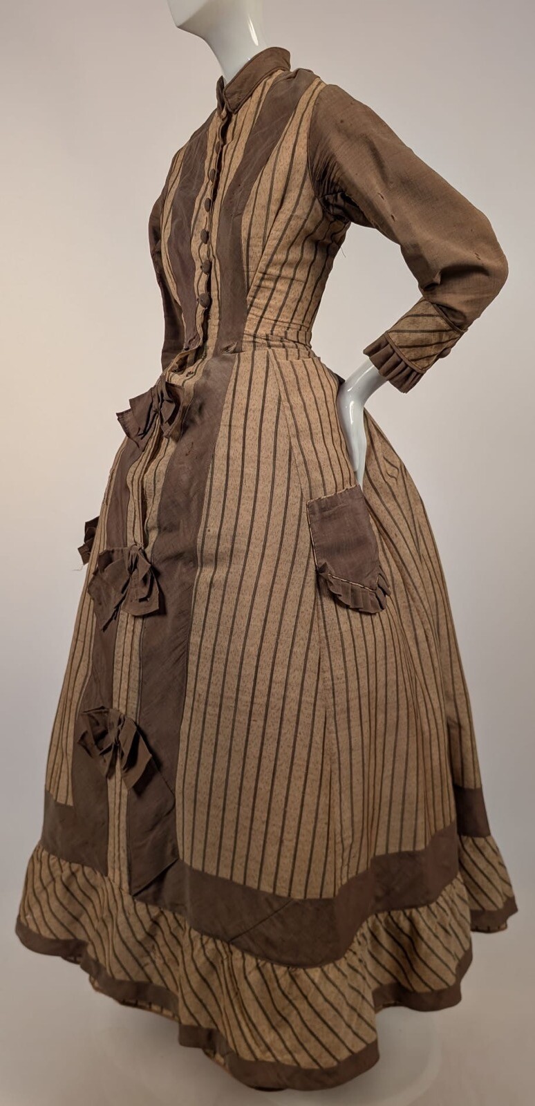 LATE 1860’S PINSTRIPED TAN BOMBAZINE DRESS W BOWS + SIDE POCKET DETAIL