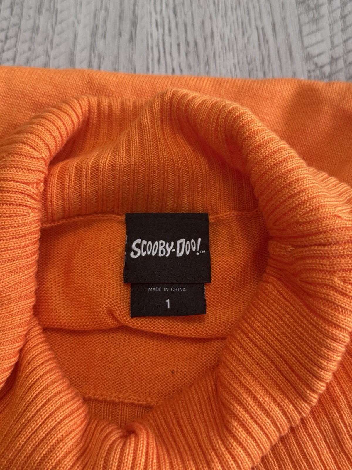 Scooby Doo Velma Turtleneck Pullover Sweater. Acrylic knit fabric. 100% acrylic.