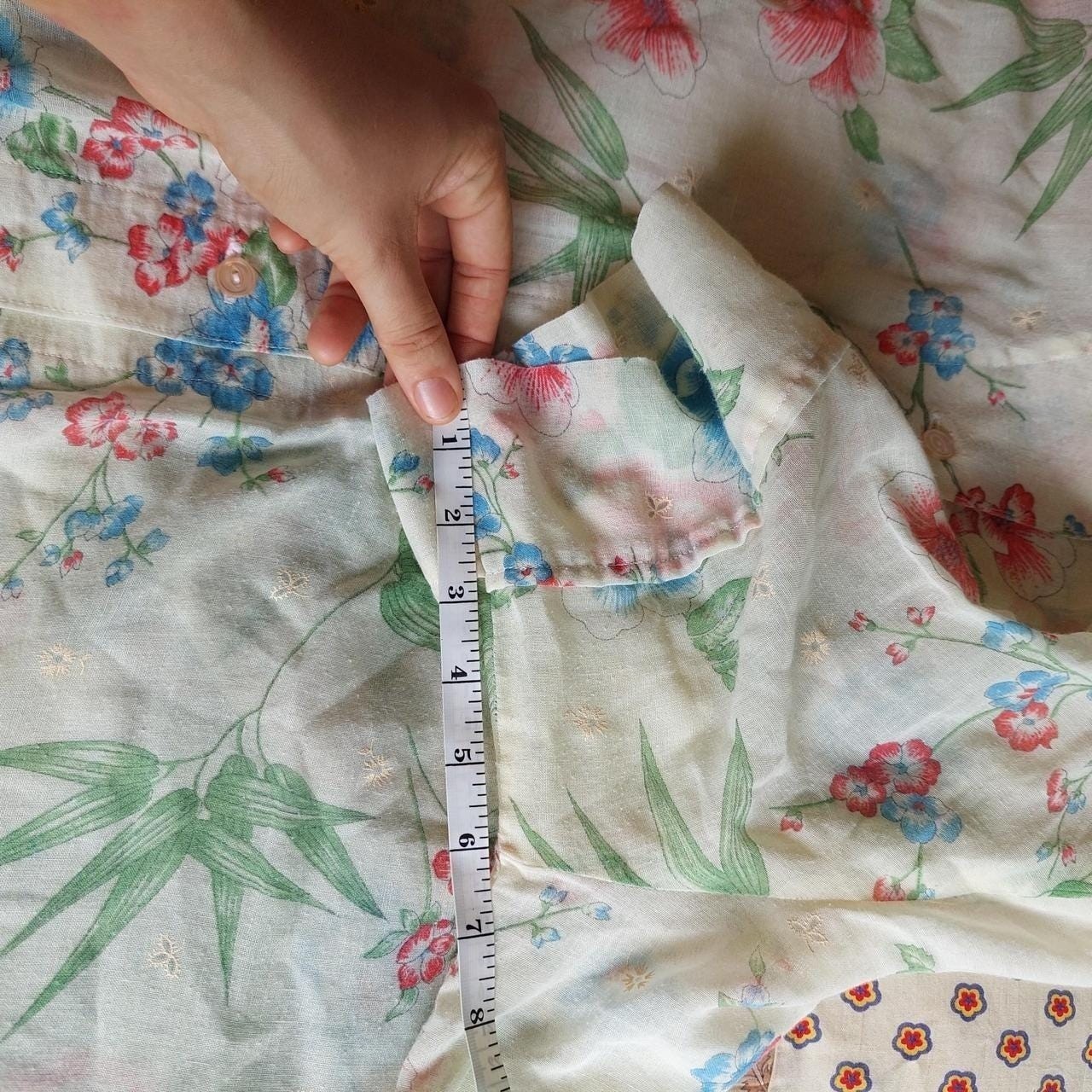 Vintage cream red, blue, and green floral short sleeve top with ruffle detail.