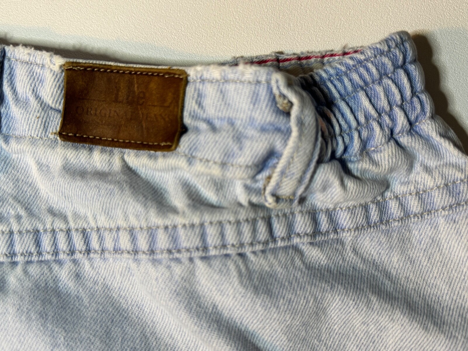 Vintage 1990’s Lee light wash denim jeans, elastic band on each side, 27″ Inseam