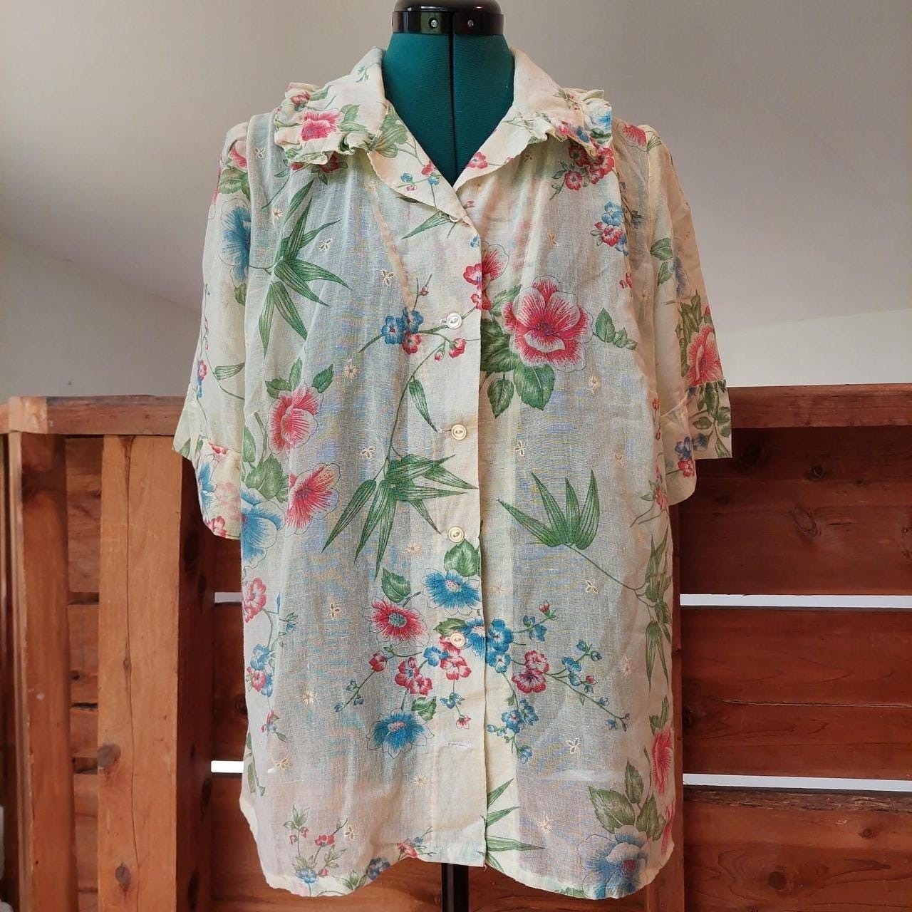 Vintage cream red, blue, and green floral short sleeve top with ruffle detail.