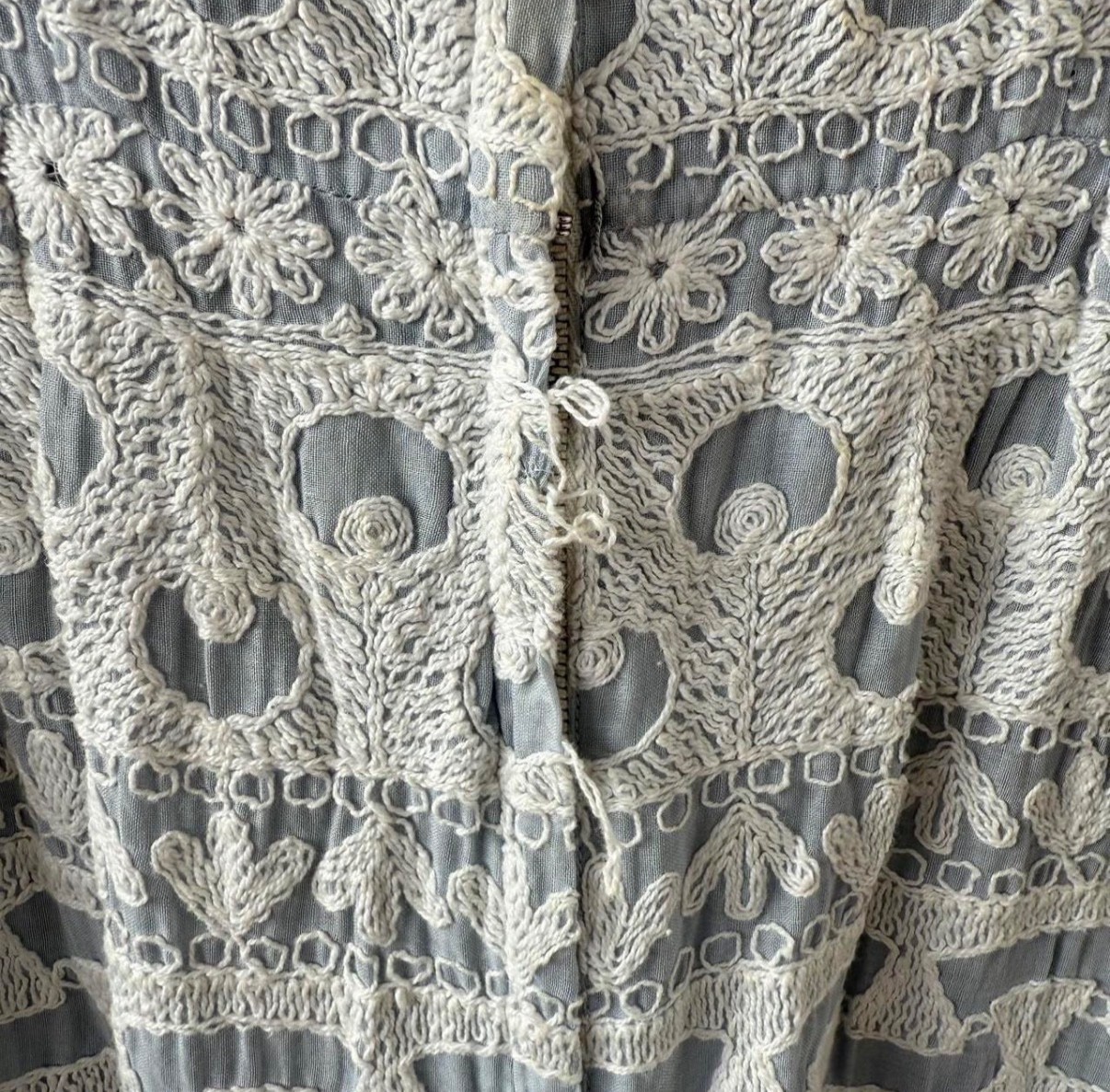 Vintage dress featuring white embroidery on soft powder blue fabric, size 6.