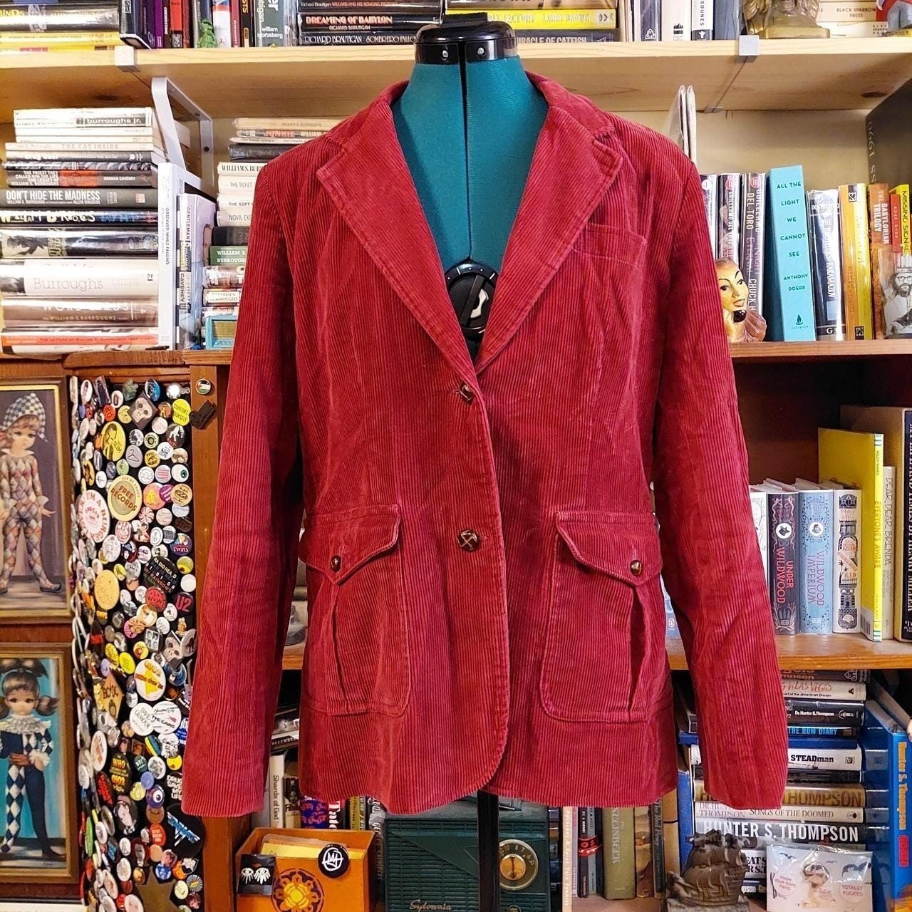 Vintage red corduroy blazer has small shoulder pads.