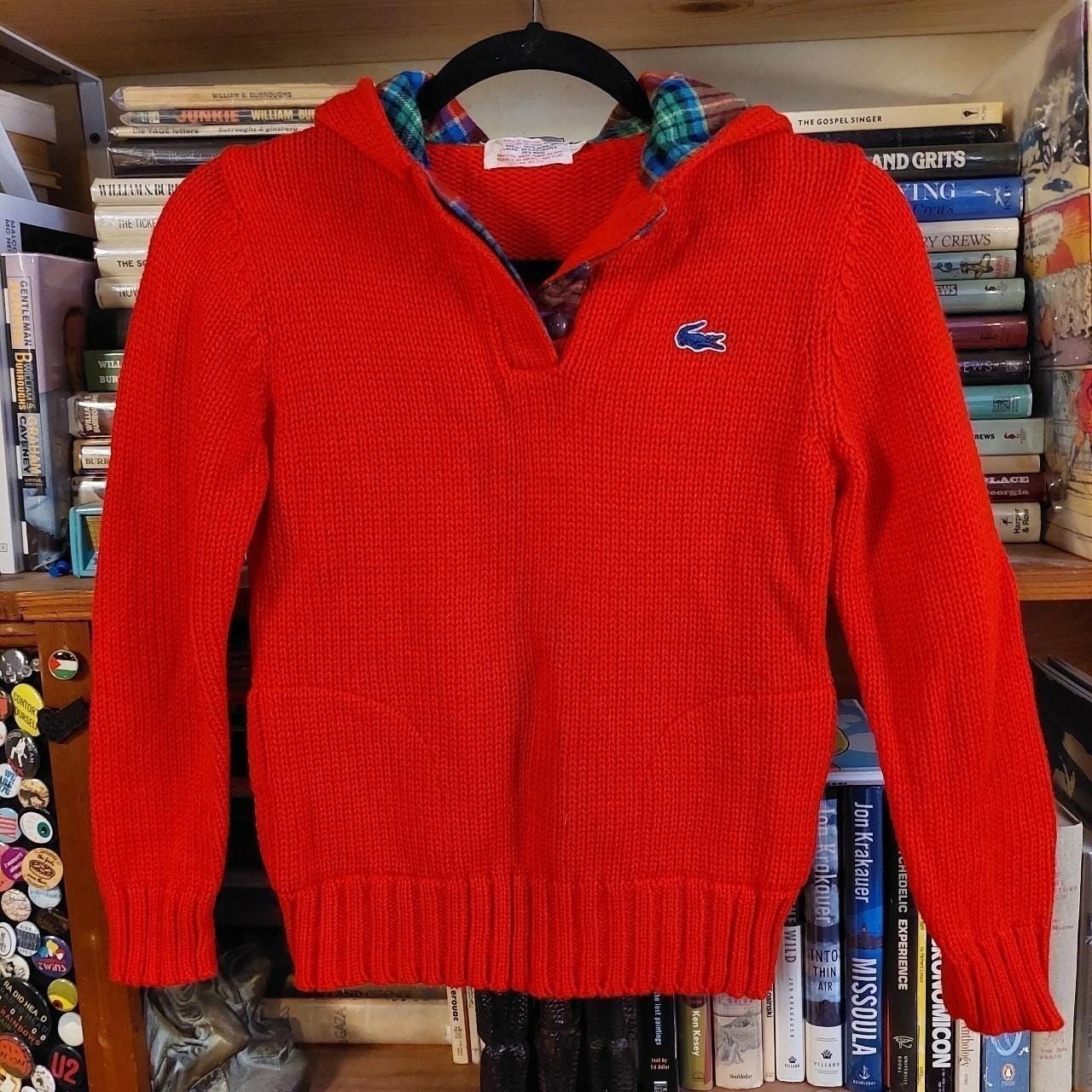 Vintage red Lacoste hooded sweater with plaid detail and pockets.