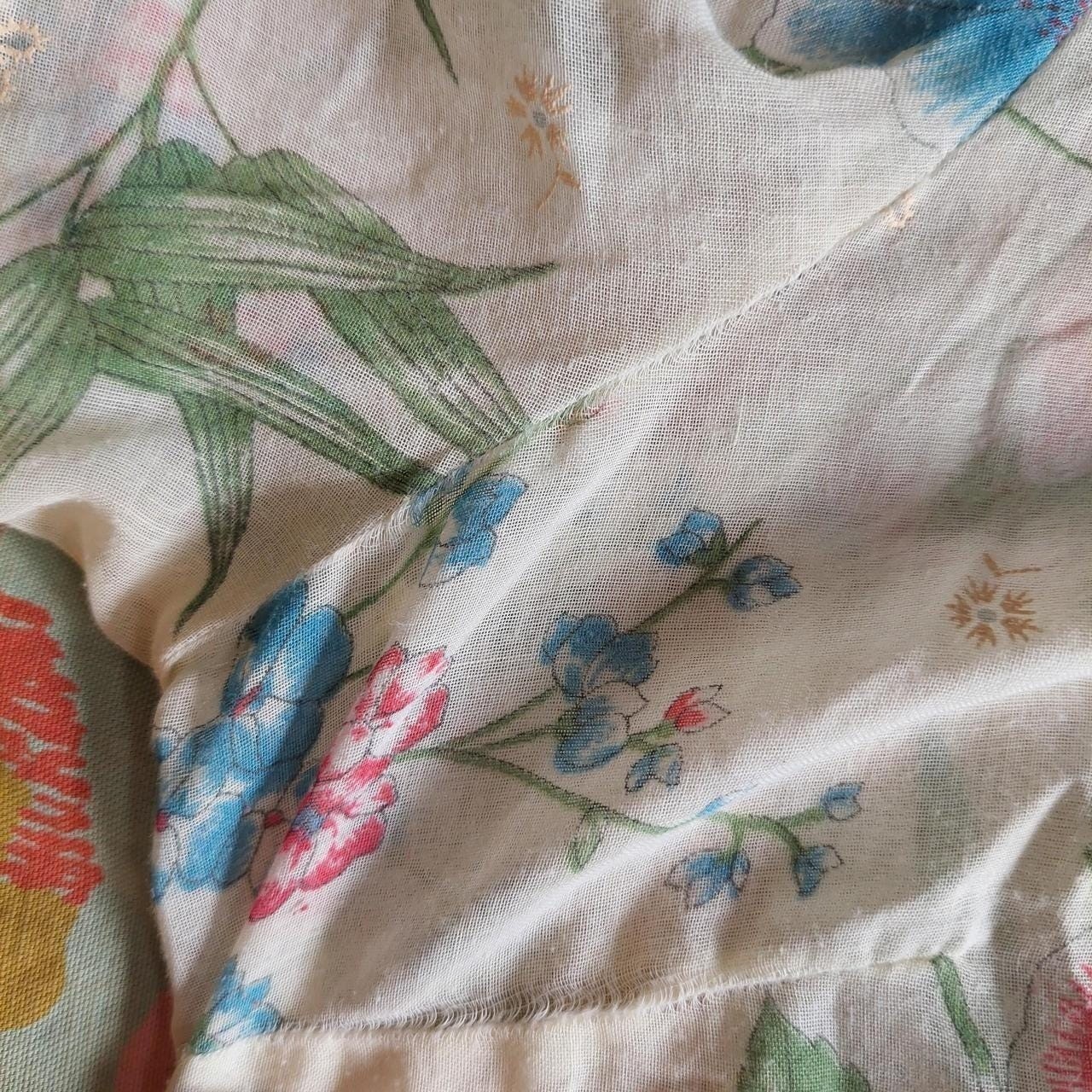 Vintage cream red, blue, and green floral short sleeve top with ruffle detail.