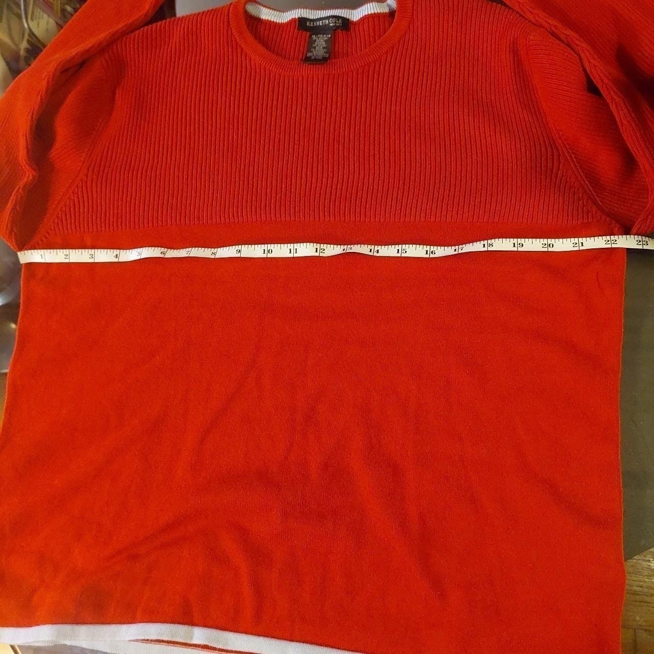 Vintage red sweater with a light blue detailing on the hemline and sleeves.
