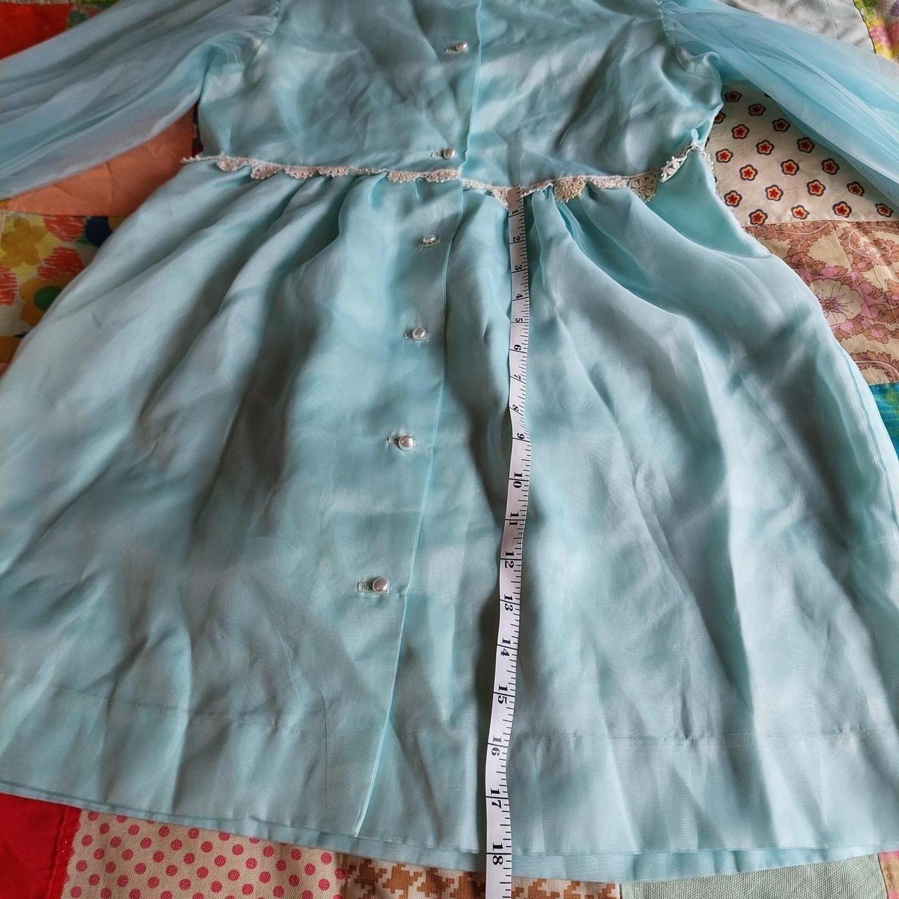Vintage baby blue dress/ tunic with sheer sleeves, lace trim, and pearl buttons.