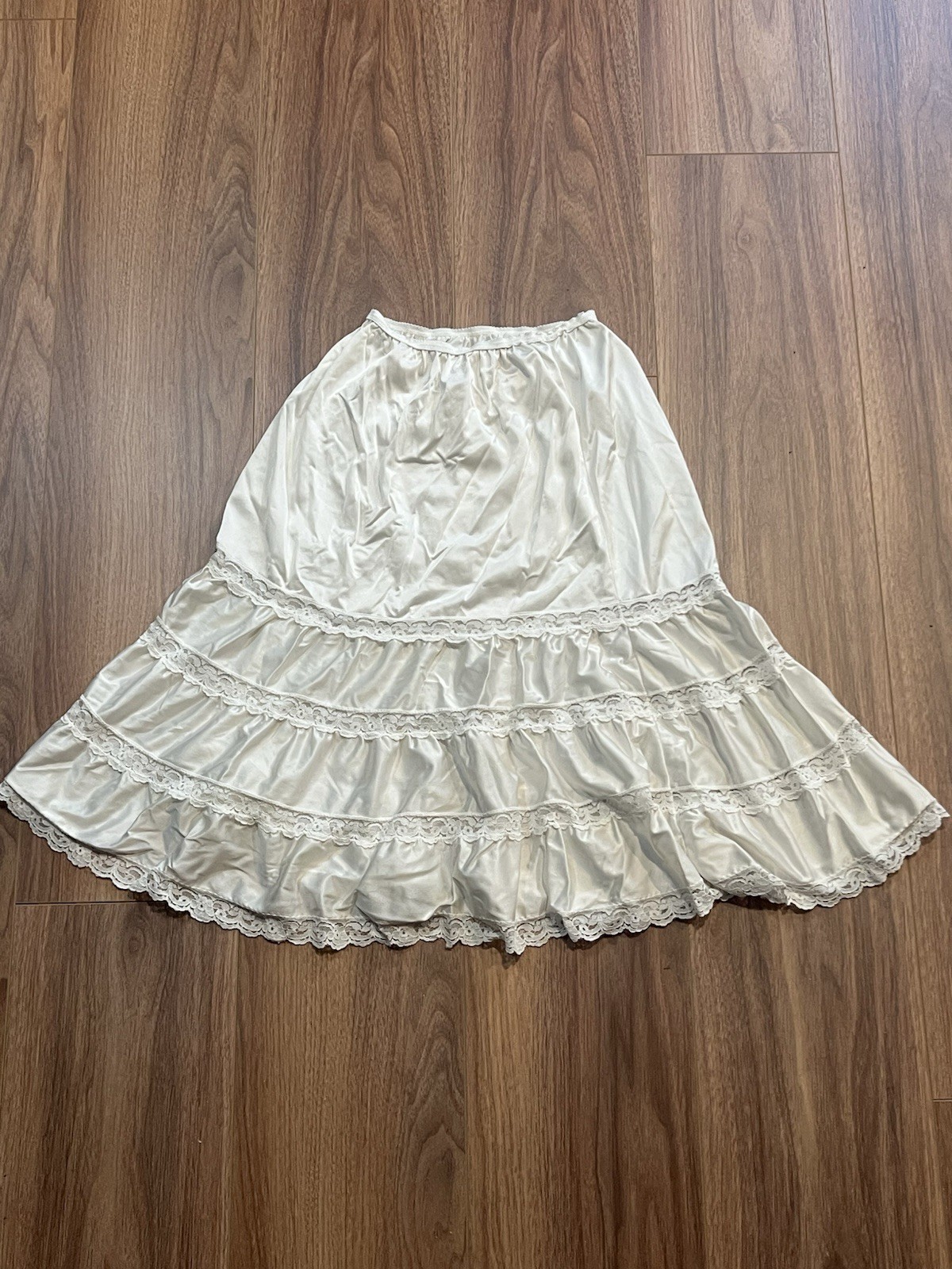 True vintage 1980s white lace trimmed skirt with elastic waistband. Length 25”