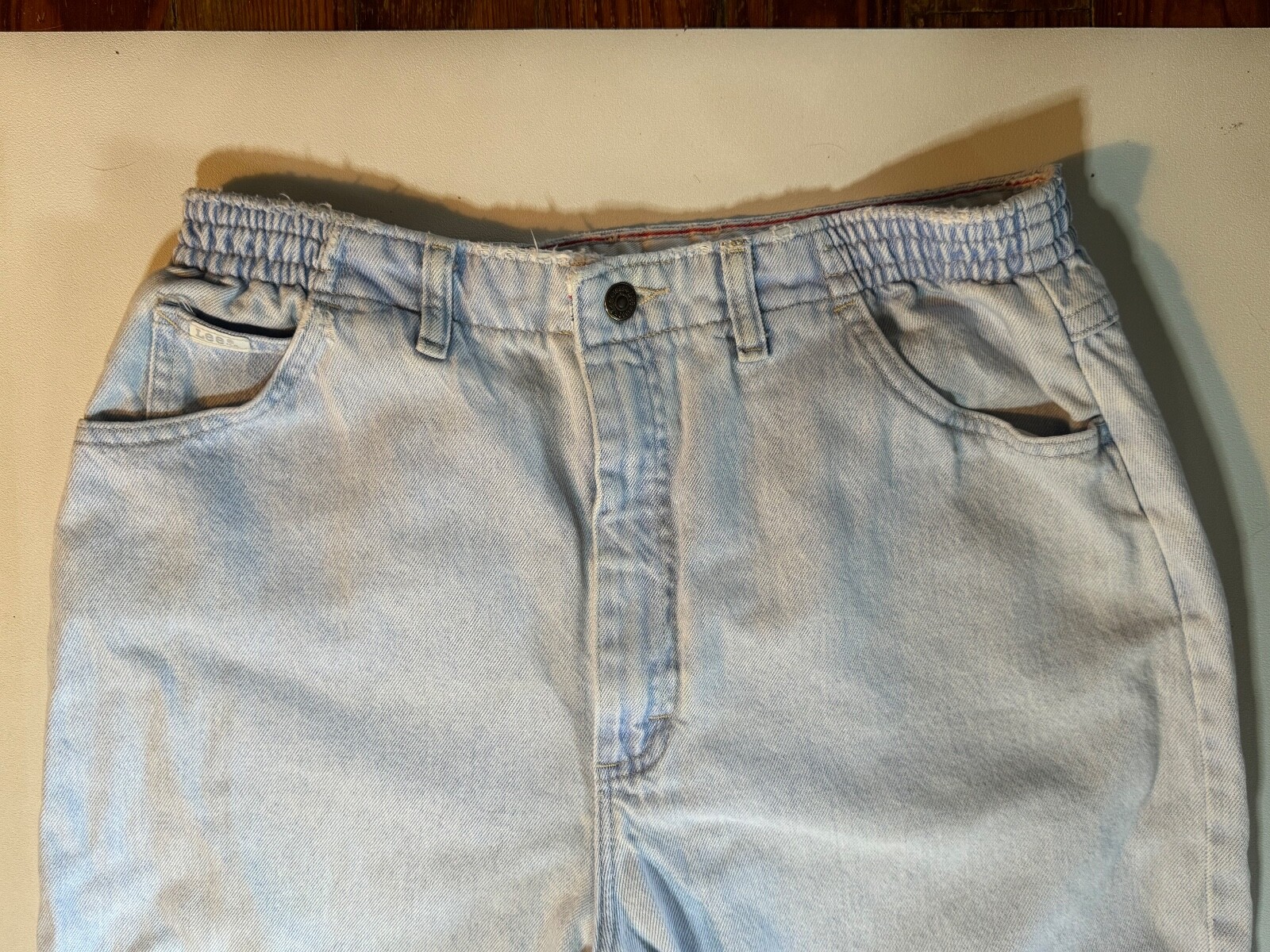 Vintage 1990’s Lee light wash denim jeans, elastic band on each side, 27″ Inseam