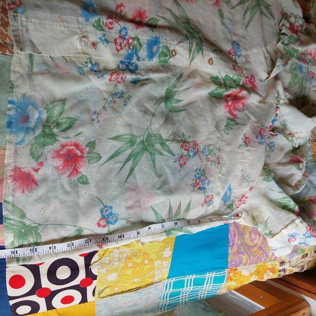 Vintage cream red, blue, and green floral short sleeve top with ruffle detail.