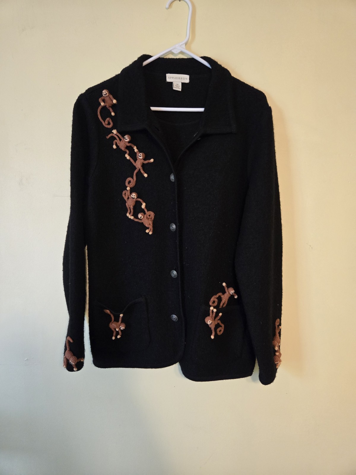 VNTG Appleseeds black cardigan adorned with 3D crocheted monkey embellishments
