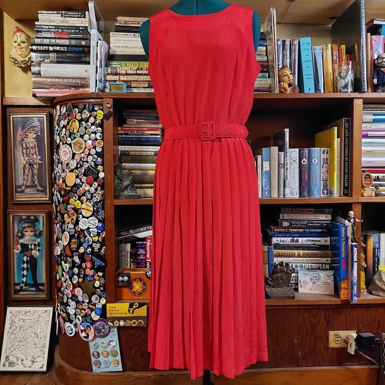 Vintage red midi dress with a pleated skirt and matching belt.