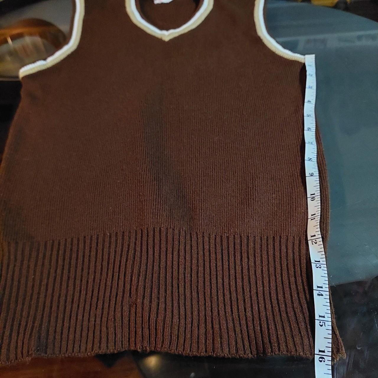 Vintage brown V-neck sweater vest with tan and white details.