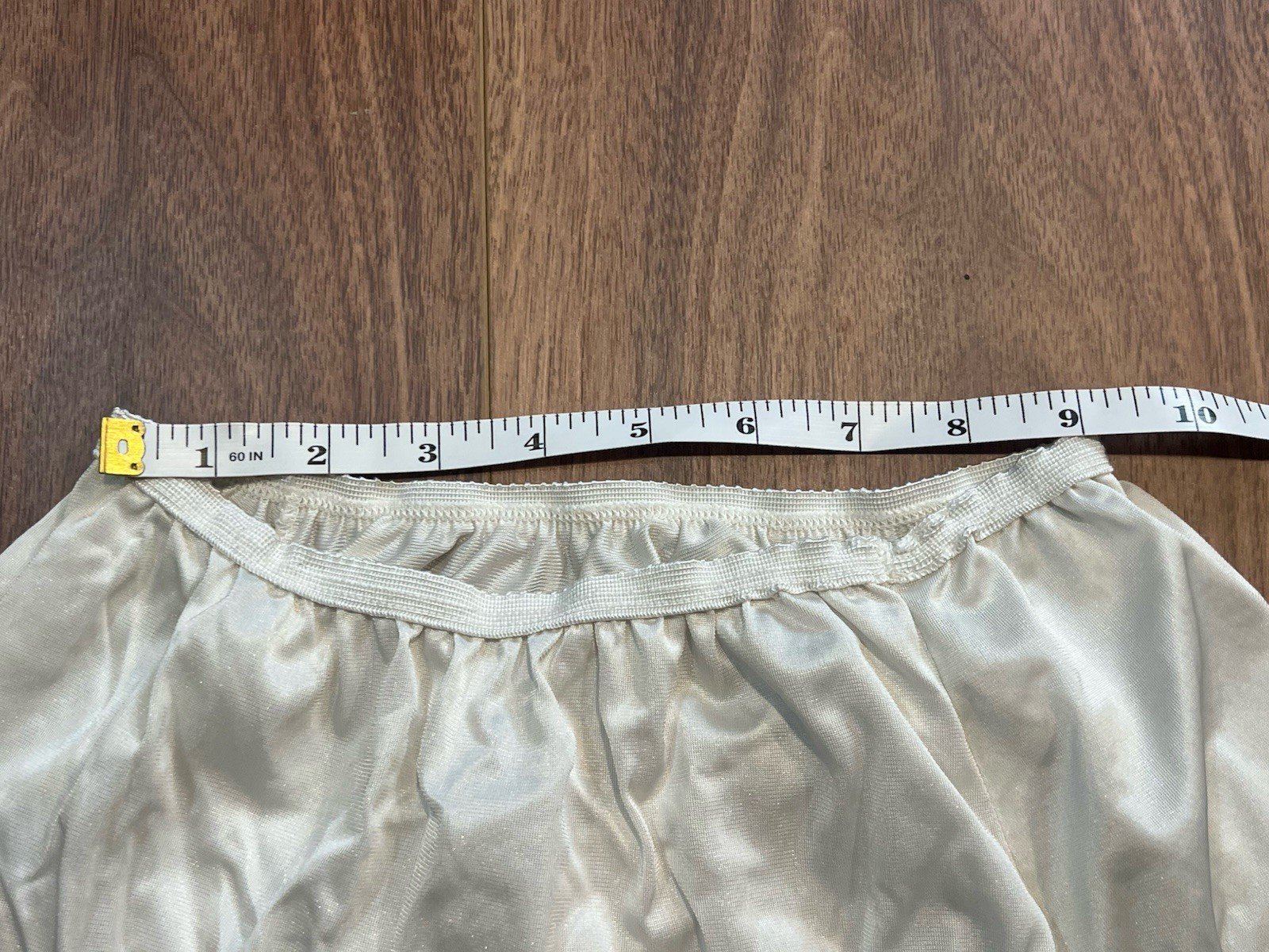 True vintage 1980s white lace trimmed skirt with elastic waistband. Length 25”