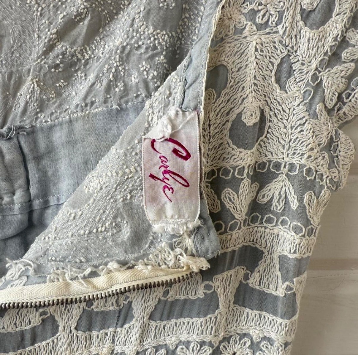 Vintage dress featuring white embroidery on soft powder blue fabric, size 6.