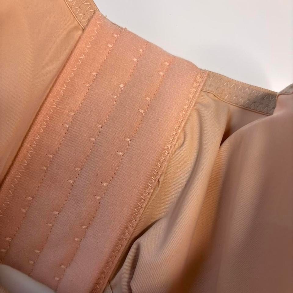 Beige strapless corset top bra with adjustable straps and hooks. Size: S