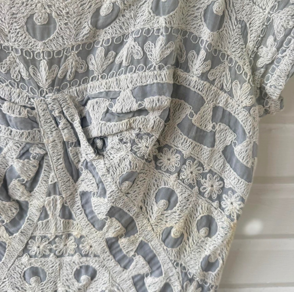 Vintage dress featuring white embroidery on soft powder blue fabric, size 6.