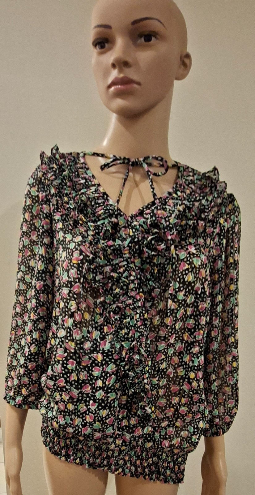 1980s black floral ruffle tie neck stretch waist blouse.