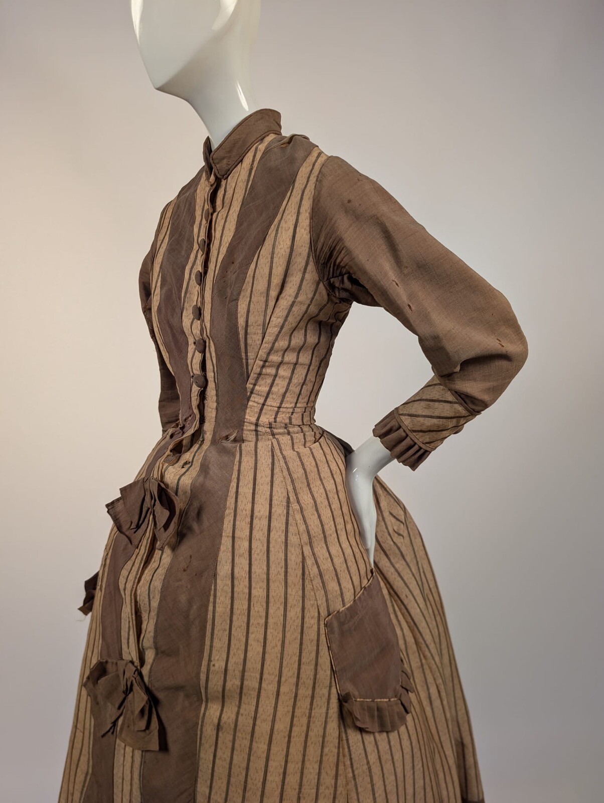 LATE 1860’S PINSTRIPED TAN BOMBAZINE DRESS W BOWS + SIDE POCKET DETAIL