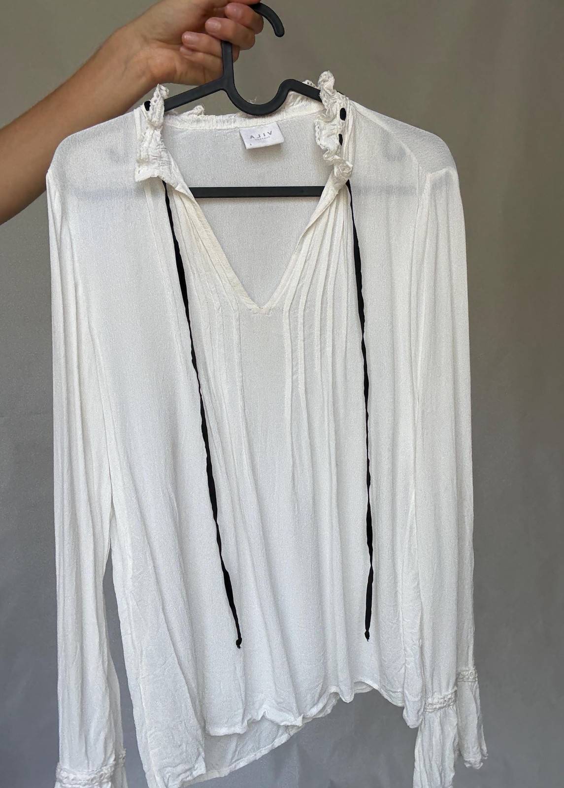 Romantic Bohemian White Blouse with Black Tie Detailing, Flowing Sleeves, and Ru