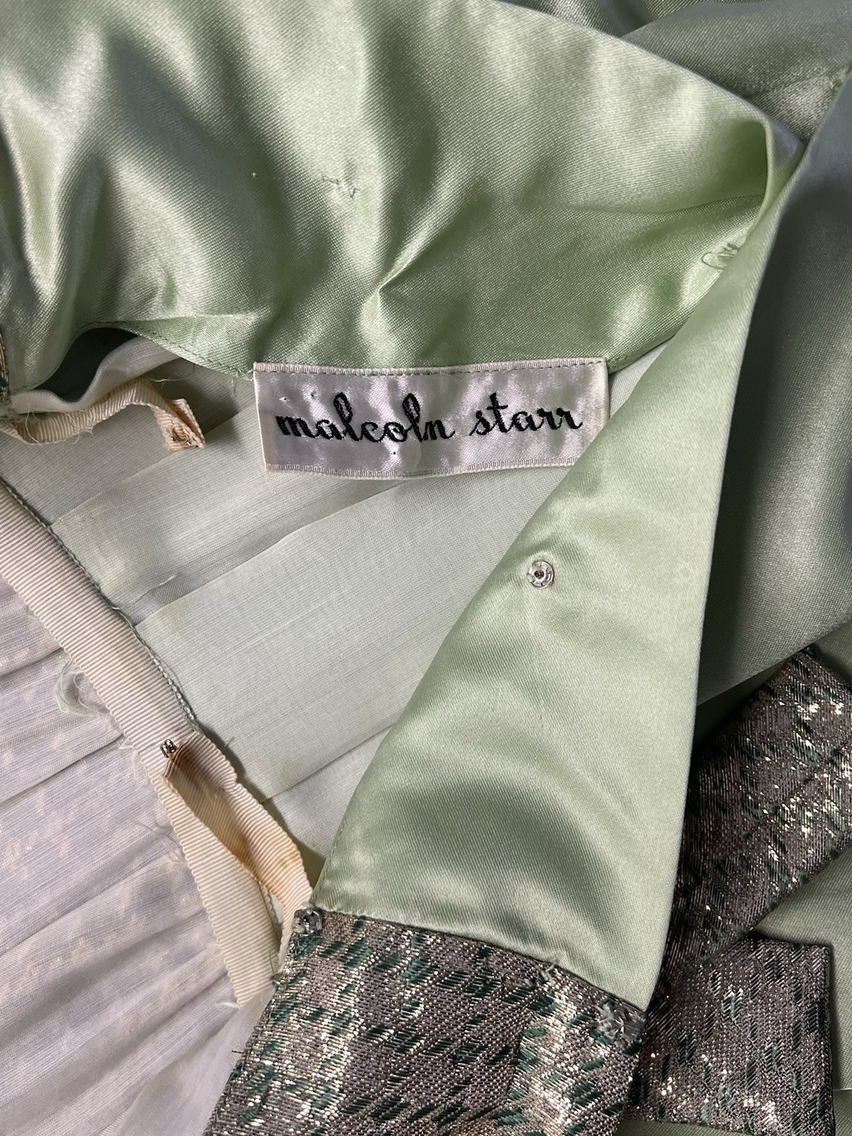 076 1960s Malcolm Starr long sleeve satin gown, pale green, metallic gold size S